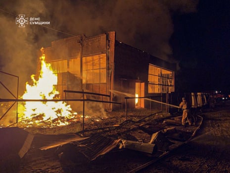 This handout photograph taken and released by the Ukrainian Emergency Service on August 20, 2025, shows a Ukrainian emergency worker in action following an air attack, in Okhtyrka, Sumy region, amid the Russian invasion of Ukraine.