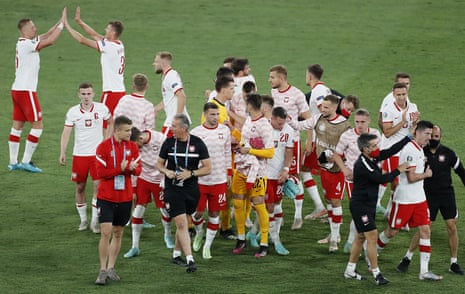 Poland’s players and staff, including goalscorer Robert Lewandowski (bottom second right) celebrate after the final whistle.