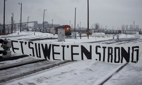 A CN train sits on the tracks behind a sign placed by supporters of the Wet’suwet’en Nation at a blockade in Montreal on 2 March.