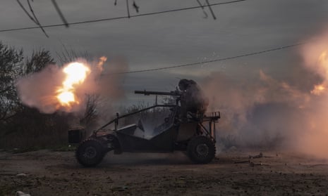 Ukrainian servicemen fire toward Russian positions in the frontline near Kherson.