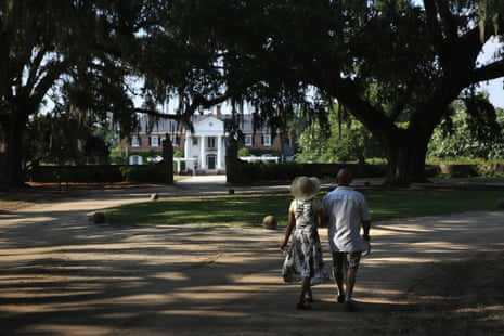 A couple walks through the grounds of the Boone Hall Plantation in Mount Pleasant, South Carolina. The plantation, founded in 1681, is one of the oldest working plantations in the US. 