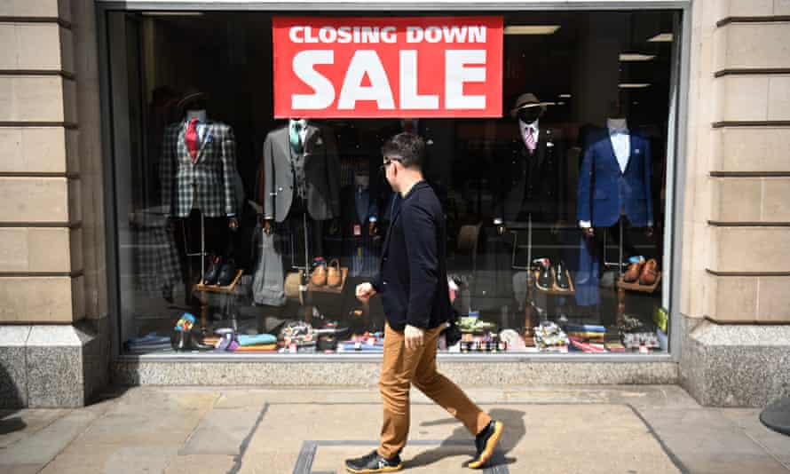 A shopper passes a sign advertising a sale in London, Britain, 12 May 2022.
