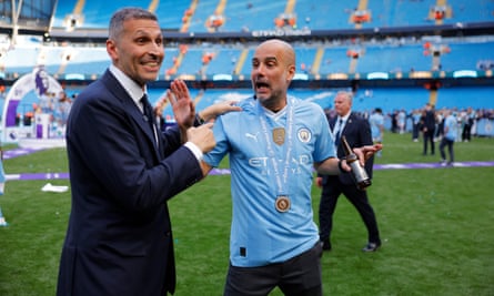 Pep Guardiola celebrates with Manchester City’s chairman, Khaldoon al-Mubarak (left), after the trophy lift.