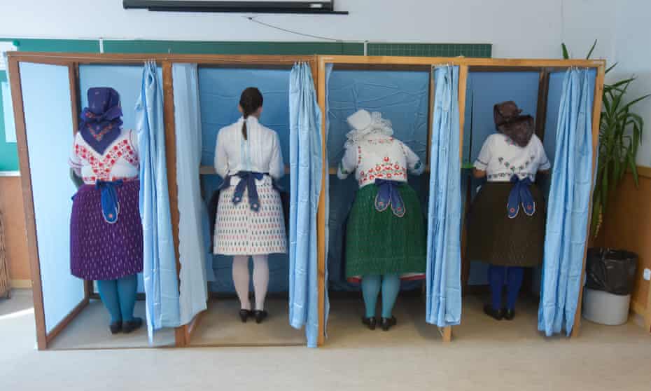 A group of Hungarian women in traditional dress vote in the country's referendum