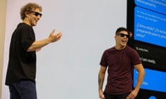 Meta’s CEO, Mark Zuckerberg, with mixed martial artist Brandon Moreno, wearing sunglasses and laughing on a stage.