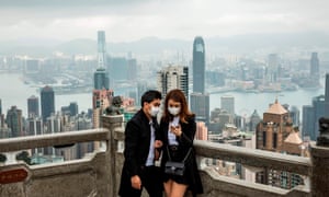 People wearing protective face masks visit the lookout of Victoria Peak in Hong Kong