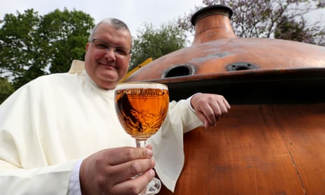 Father Karel Stautemas poses with a Grimbergen beer in the courtyard of the Belgian Abbey of Grimbergen