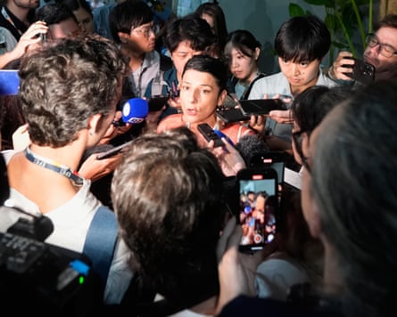 Irene Vélez Torres, Colombia's minister of environment and sustainable development surrounded by a gaggle of media representatives recording her comments on voice recorders and smartphones