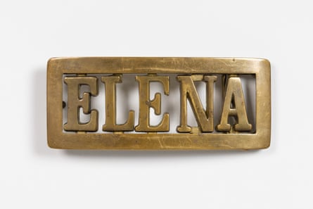 brass-colored buckle says ‘elena’