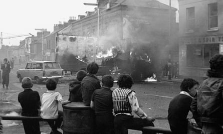 ‘Lots of people didn’t want to know’ … children watch hijacked vehicles burn following rioting in Belfast in 1976.