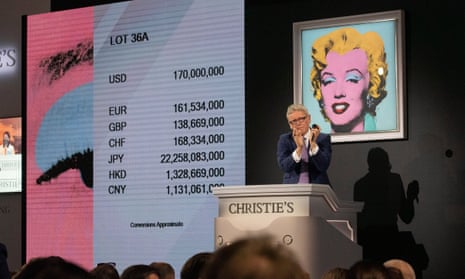 Christie's auctioneer claps after ending the auction of Shot Sage Blue Marilyn by Andy Warhol which sold for $170m plus fees.