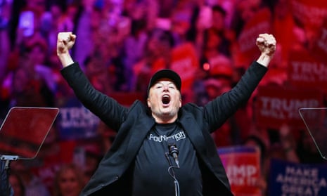 A man pumps his fists and shouts in front of a crowd