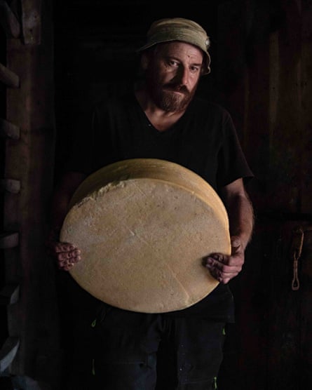 Oreste Pedrelli holding a wheel of cheese