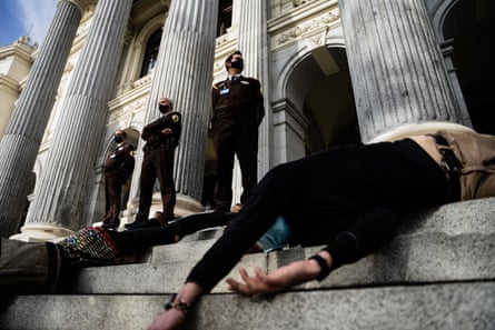 people laying down on stone steps outside a building