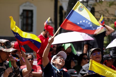 people hold yellow blue and red flags