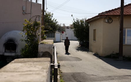 An elderly man in an empty village street