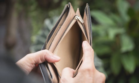 Close-up of woman's hands holding open empty purse