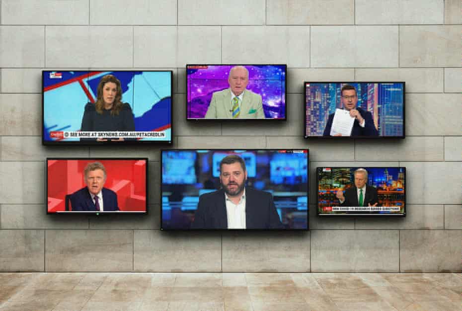 Flat screens hanging on a wall showing presenters from Sky News programs