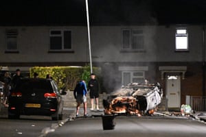 Cardiff, Wales An upturned car burns during unrest after a fatal road crash on Snowden Road on Monday night. Fires were started and objects thrown at officers after rumours on social media wrongly blamed police for the incident