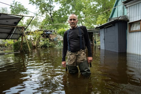 Ihor Medyunov stands in the courtyard of his flooded house in the island of Kakhovka reservoir on Dnipro River near Lysohirka