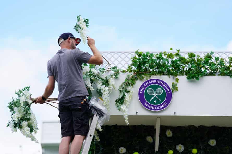 Flowers are put into place during final preparations for the tournament