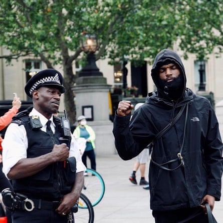 Faron with a police officer at the protest in London on Sunday.