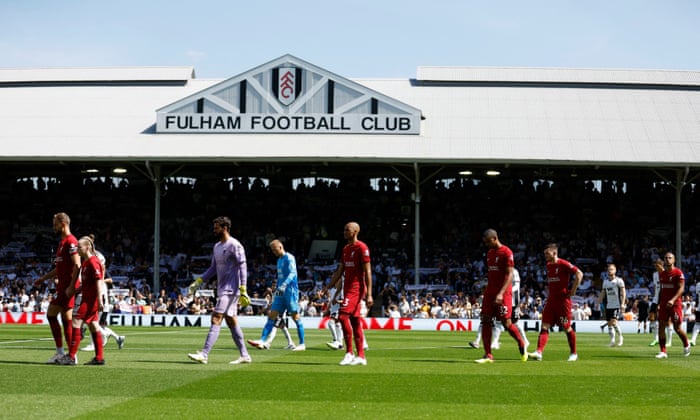 Liverpool’s Jordan Henderson leads his teammates out before the match.