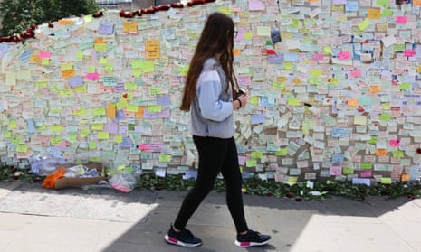Girl walks past wall of Post-It notes