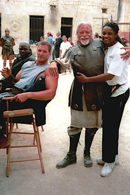 Oliver Reed in a playful mood with members of the cast on the set of Gladiator.
