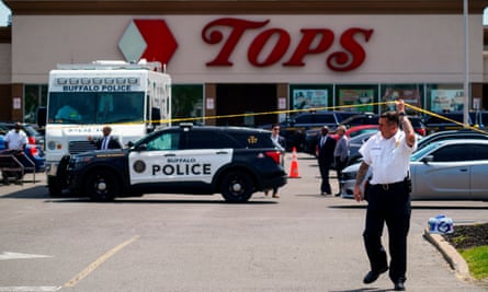 A police officer lifts the tape cordoning off the supermarket in Buffalo following the shooting in May 2022.