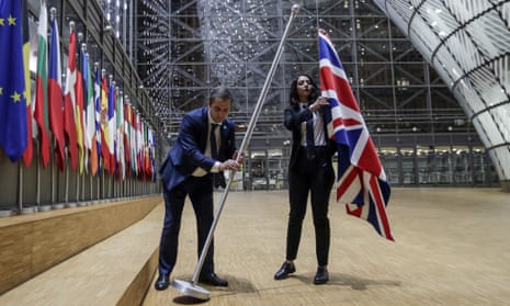 Staff remove the union flag from the European council building in Brussels on Brexit Day.