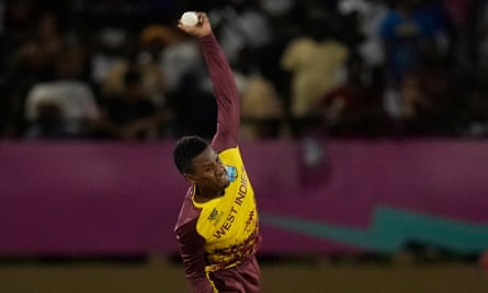 West Indies’ Akeal Hosein bowls against Uganda