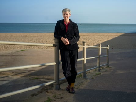 Polly Billington stands next to a beach.