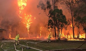 Firefighters tackle a bush fire in Sydney.