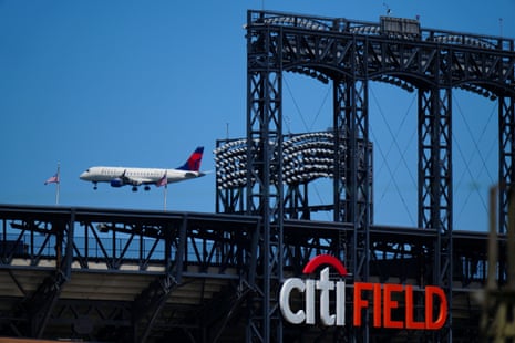 A Delta Airways plane flies over Citi Field.