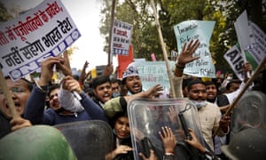 Security officers push back people shouting slogans during a protest to show support to farmers in New Delhi, India, 3 February 2021
