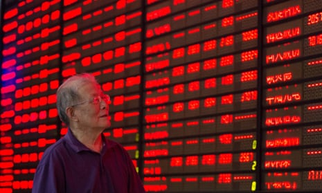 An investor looks at the price of shares in Nanjing, China.