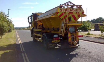 A gritter spreads rock dust on the road surface in Cumbria.