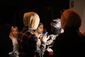 Models getting final touches to their make-up backstage before walking the runway