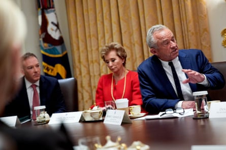 Two men and a woman seated at a table.
