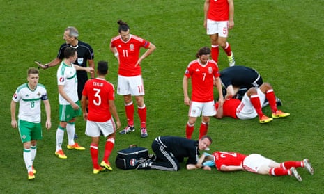 Wales’ Ashley Williams and Jonathan Williams receive treatment after colliding.