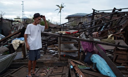 A Filipino villager stands next to his damaged house in the typhoon-hit town of Casiguran, northern Manila.