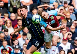 Laporte and Barnes battle for a high ball.