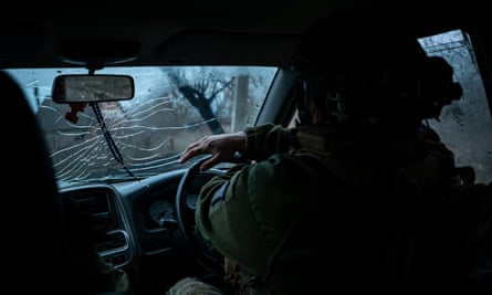 A Ukrainian serviceman driving along the frontline outside Soledar in March