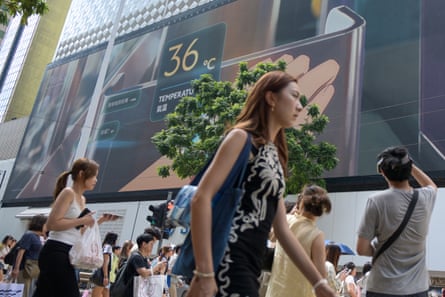 Residents walk in Causeway Bay on 9 August, as Hong Kong posted its highest official temperature since records began.