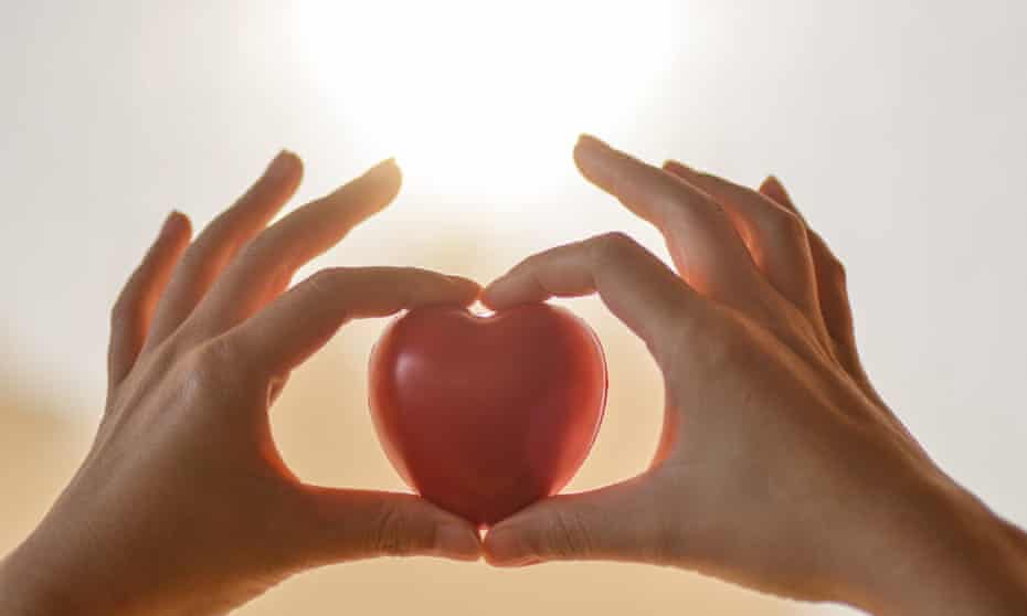 Hands holding a heart-shaped figure