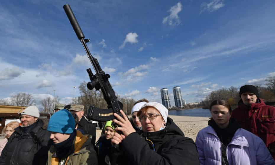 People attend an open training session organised for civilians by war veterans and volunteers who teach basic weapons handling and first aid on one of Kiyv's city beaches.