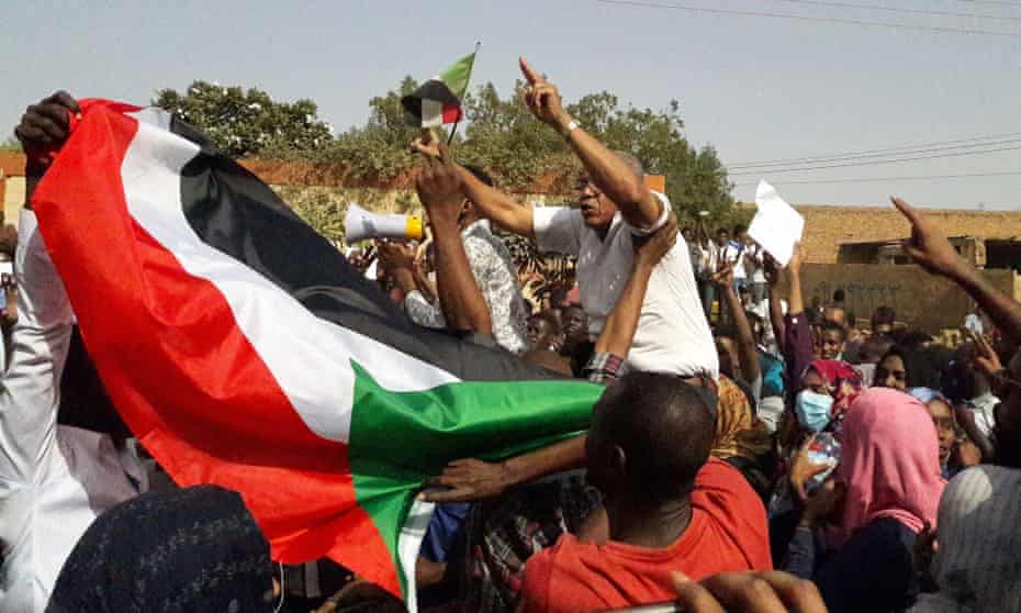 Sudanese protesters wave the national flag during an anti-government demonstration in the capital Khartoum’s twin city of Omdurman. 