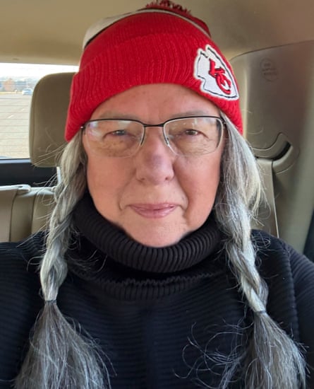Alese Johnston sitting in a car wearing a Kansas Chiefs hat
