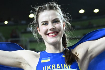 Yaroslava Mahuchikh celebrates with a Ukraine flag